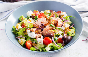 Ketogenic lunch. Greek salad with grilled salmon. Healthy dinner. Keto, paleo diet.