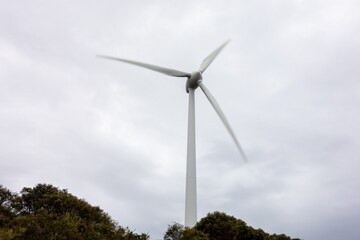 Wind turbine with motion blur effect in the Albany Wind Farm, AUstralia during overcast weather as...