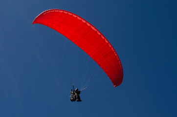 paraglider taking off in deep blue sky