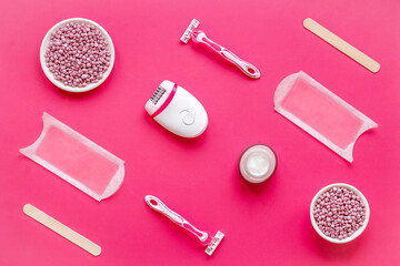 Set of epilation means - epilator with wax strips, razor and flowers. Top view