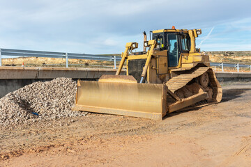 Excavator making earth movements for the construction of a road