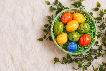 Easter card. Flat lay composition with easter eggs in a basket on white background.