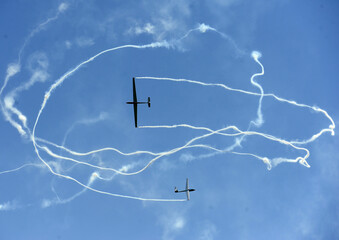 Formation of planes of the blue cloudy sky during the airshow.