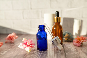 bottles and a pipette with hyaluronic serum for cosmetic and cosmetic procedures on a wooden...