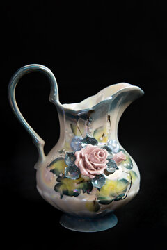 multicolored jug with stucco flowers