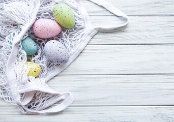 String bag with Easter eggs and spring blossom