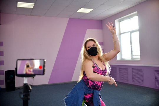 A Young Blonde Girl The Trainer Of A Zumba Wears A Black Mask During A Pandemic Leads Training Sessions In A Port Club.