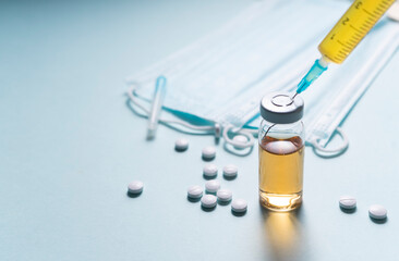 selective focus. a single-use syringe with a vaccine, a serum from the virus. Antiviral drug for Covid-19 and seasonal diseases. flatlay