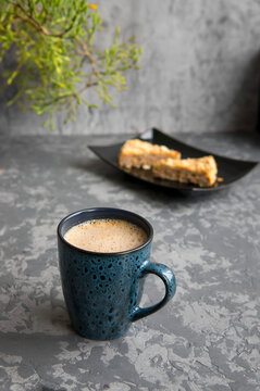 The cup of cappuccino on gray concrete table with almond cake. Breakfast concept. Selective focus, stories format