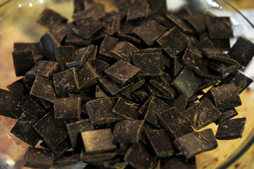 Pieces of natural chocolate waiting to be used for various dishes. Product photography.
