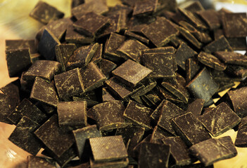 Pieces of natural chocolate waiting to be used for various dishes. Product photography.