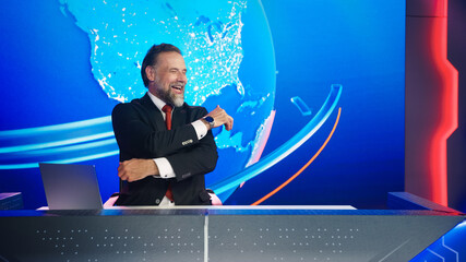 Live News Studio with Charismatic Male Newscaster Laughing out loud. Talk Show Host Tells Joke, Has...