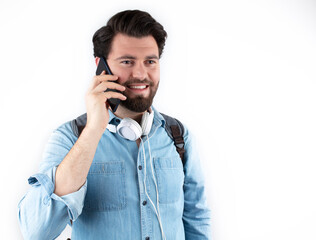 Fototapeta premium Cheerful young man student holding mobile phone. Isolated on white background