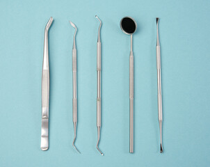 metal medical items of the dentist on a blue background