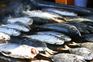 Barbecue with ocean fish at a culinary fair. Outdoor photography.