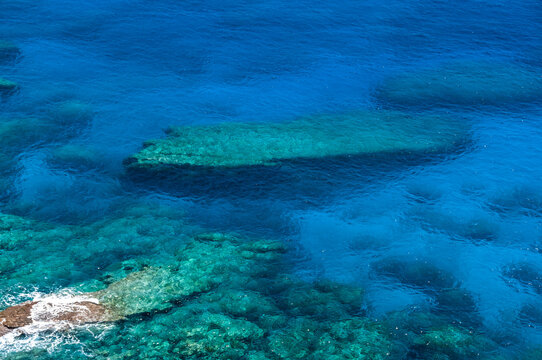 Top view of an impressive transparent blue see and that you can see some rocks under the water. Yonaguni Island.