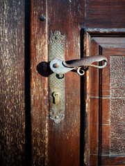 Old decorative door handle and keyhole on the door
