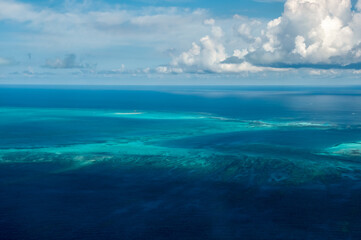 Fototapeta premium Exceptional view of coral reefs with its clear blue and green waters seen from the plane