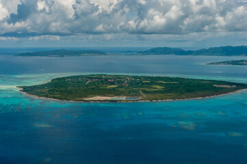 Plakat Exceptional view of Kuro island and coral reefs with its clear blue and green waters seen from the plane.
