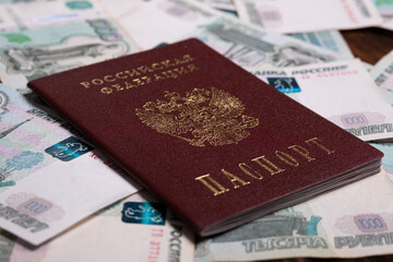 Russian passport with money for shopping abroad, travel and entertainment. Money is lying on wooden background.