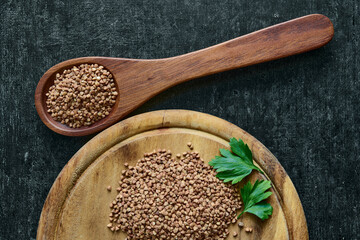 Buckwheat on cutting board and in wooden, top view