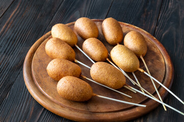 Corn dogs on wooden board