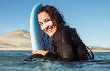 Deurstickers Canarische Eilanden Woman surfing in the sea with a yellow surfboard