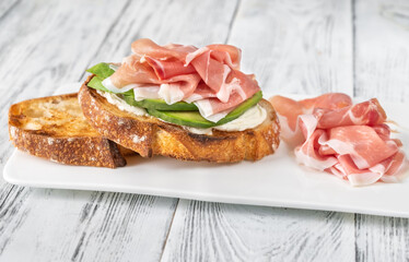 Toast with avocado, prosciutto and cream cheese
