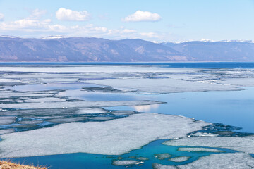 Baikal Lake in the springtime. Top view of the ice drift in the Small Sea Strait. Beautiful water landscape. Change of seasons. Natural spring background