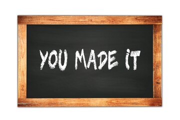 Obraz premium YOU MADE IT text written on wooden frame school blackboard.