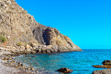 Fototapeta na wymiar beautiful sea bay among the rocks on a sunny summer day