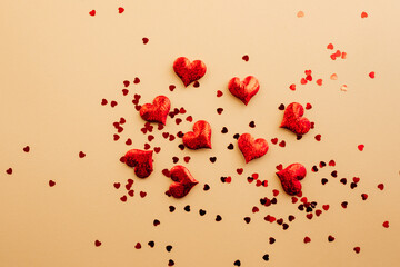 Red sparkle hearts scattered on the beige background