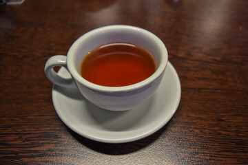 Warm tea cup on put on wooden table in the morning.