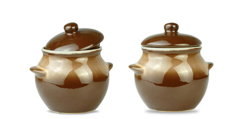 Brown clay pots for cooking on a white isolated background. Utensils for baking food.