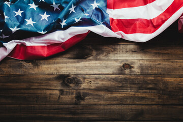 July 4, U.S. Independence Day image with U.S. flag on wooden background. View from above. Flat floor. Copy space.