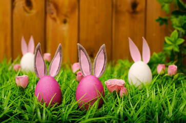  Easter eggs in meadow grass on a wooden background