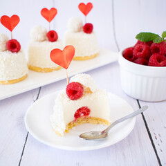 Coconut-flavored dessert with raspberries for Valentine's Day. Mini cheesecakes in mono portions.