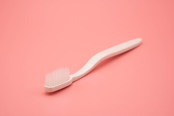 Natural toothbrush on pink background.