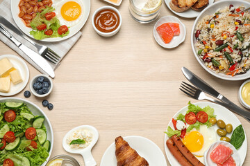 Frame made with different dishes on buffet table, flat lay. Space for text