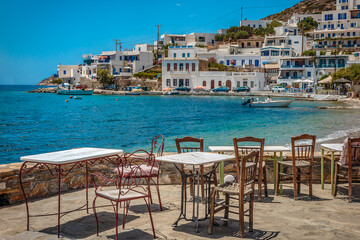 Fototapeta na wymiar View accross the local cafe terrace to the waterfront at Amorgos, Greece