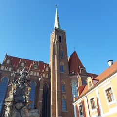 Fototapeta na wymiar Catholic church on Tumski island of Wroclaw, Poland. Collegiate Church of the Holy Cross and St. Bartholomew.