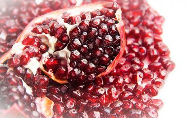 Slice of juicy pomegranate with water drops.