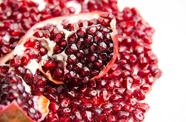 Slice of juicy pomegranate with water drops.