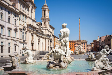 Piazza Navona, a beautiful example of Baroque Roman architecture with Fontana del Moro (Moor Fountain) in foreground and Fontana dei Quattro Fiumi (Four Rivers) in background. Rome, Italy
