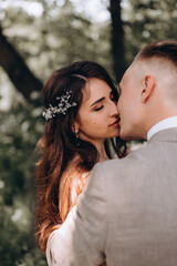 Naklejka premium Walking the bride and groom outdoors. Beautiful summer photo session in nature.