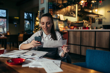 manager dealing with finances in her restaurant