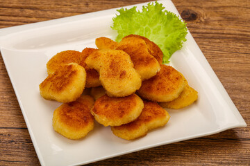 Fried chicken nuggets served salad leaves