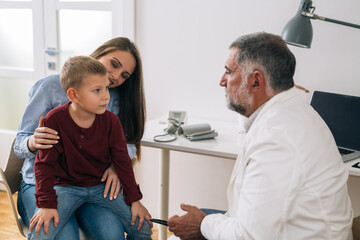 Fototapeta premium young boy with his mother visit pediatrician