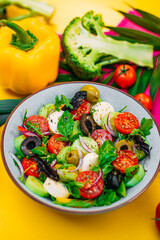 healthy food. Greek Salad with cheese, cucumbers, tomatoes and olives on a decorated table