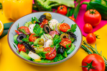 healthy food. Greek Salad with cheese, cucumbers, tomatoes and olives on a decorated table